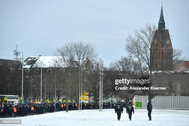 Police forces secure Kurds as they participate in celebrations marking the Kurdish new year, or Newroz, on March 17, 2018 in Hanover, Germany. Many...