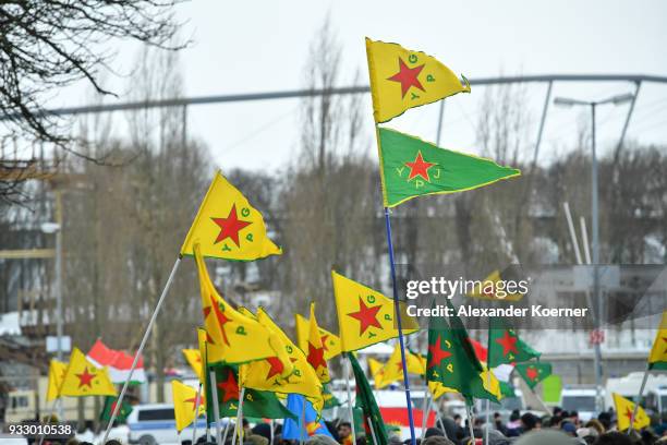 Expatriate Kurds carry YPG flages as they participate in celebrations marking the Kurdish new year, or Newroz, on March 17, 2018 in Hanover, Germany....