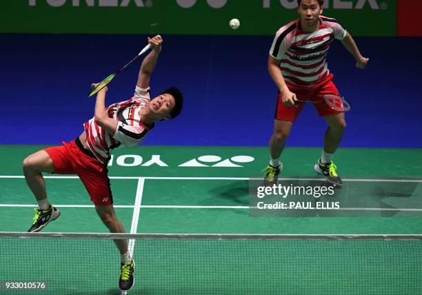 Indonesia's Marcus Fernaldi Gideon and Kevin Sanjaya Sukamuljo return against Denmark's Mads Conrad-Petersen and Mads Pieler Kolding during their...