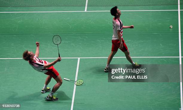 Indonesia's Marcus Fernaldi Gideon and Kevin Sanjaya Sukamuljo celebrate beating Denmark's Mads Conrad-Petersen and Mads Pieler Kolding during their...