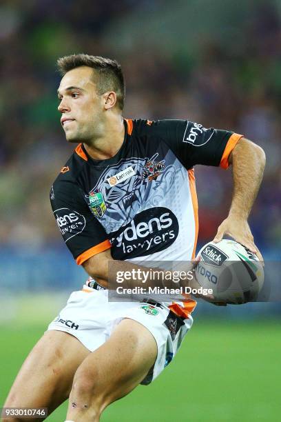 Luke Brooks of the Tigers passes the ball during the round two NRL match between the Melbourne Storm and the Wests Tigers at AAMI Park on March 17,...