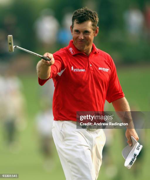 Lee Westwood of England waves to the crowd on the 18th hole on his way to victory in the Dubai World Championship and the Race To Dubai on the Earth...