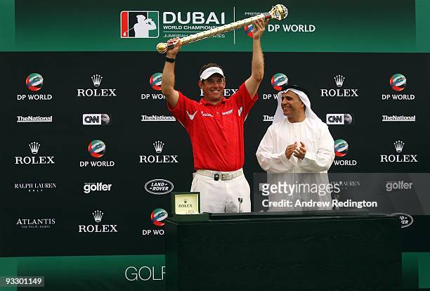 Lee Westwood of England poses alongside His Excellency Matar al Tayer with the Dubai World Championship trophy after winning the Dubai World...