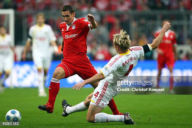 Sami Hyypiae of Leverkusen tackles Miroslav Klose of Bayern during the Bundesliga match between Bayern Muenchen and Bayer Leverkusen at the Allianz...
