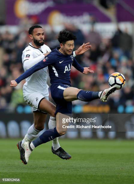 Heung-Min Son of Tottenham Hotspur challenged by Kyle Bartley of Swansea City during The Emirates FA Cup Quarter Final match between Swansea City and...