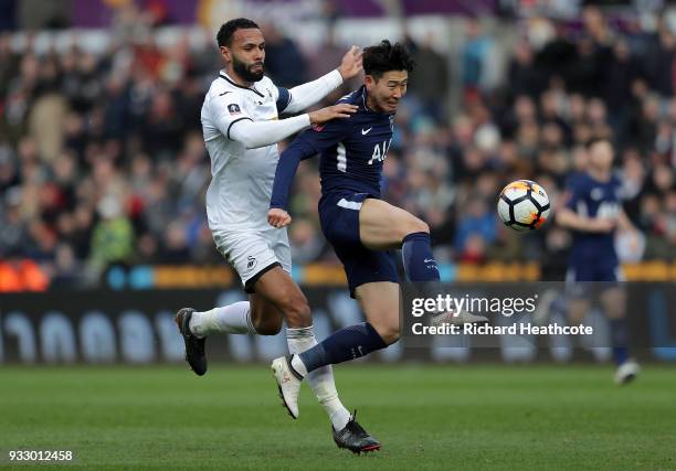 Heung-Min Son of Tottenham Hotspur challenged by Kyle Bartley of Swansea City during The Emirates FA Cup Quarter Final match between Swansea City and...