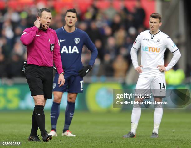 Refree Kevin Friend consults VAR before ruling Heung-Min Son of Tottenham Hotspur's goal offside during The Emirates FA Cup Quarter Final match...