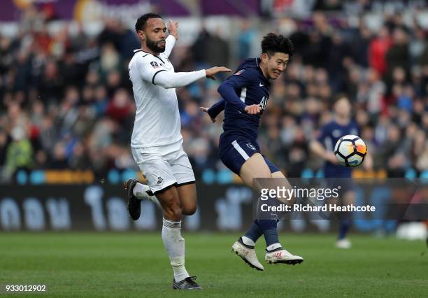 Heung-Min Son of Tottenham Hotspur challenged by Kyle Bartley of Swansea City during The Emirates FA Cup Quarter Final match between Swansea City and...