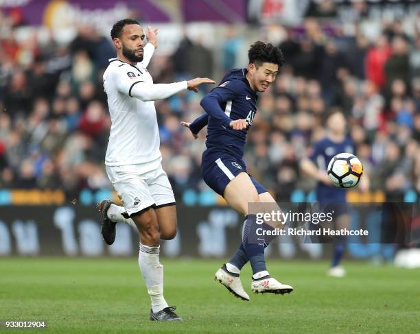 Heung-Min Son of Tottenham Hotspur challenged by Kyle Bartley of Swansea City during The Emirates FA Cup Quarter Final match between Swansea City and...