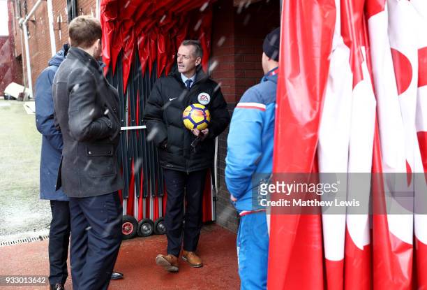 Referee Martin Atkinson looks on from the tunnel prior to the Premier League match between Stoke City and Everton at Bet365 Stadium on March 17, 2018...