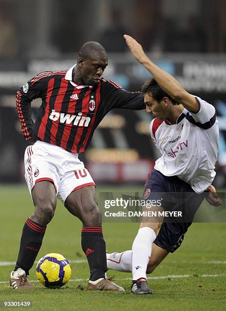 Milan's Dutch midfielder Clarence Seedorf fights for the ball with Cagliari's defender Davide Astori during their Italian Serie A football match...