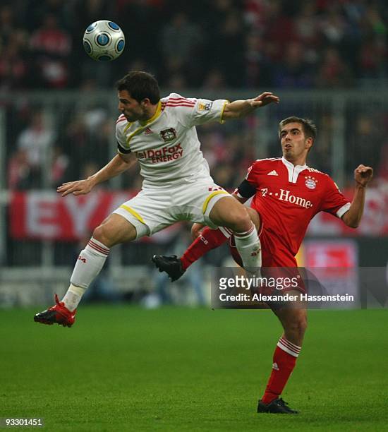 Philipp Lahm of Bayern Muenchen is challenged by Gonzalo Castro of Bayer Leverkusen during the Bundesliga match between FC Bayern Muenchen and Bayer...