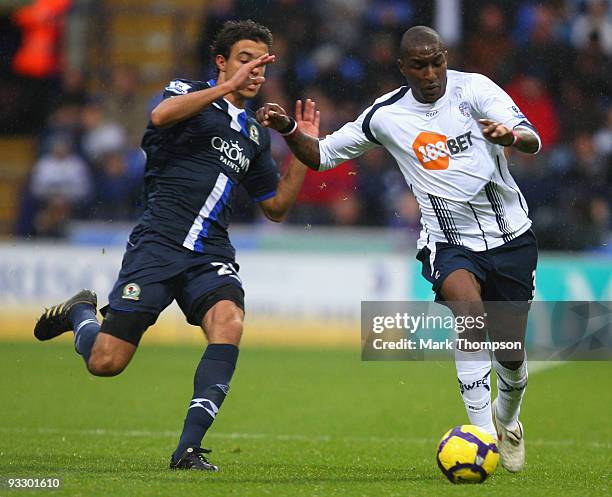 Jlloyd Samuel of Bolton Wanderers tangles with Franco Di Santo of Blackburn Rovers during the Barclays Premier League match between Bolton Wanderers...