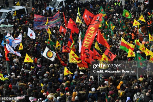 Expatriate Kurds carry YPG flags as they participate in celebrations marking the Kurdish new year, or Newroz, on March 17, 2018 in Hanover, Germany....