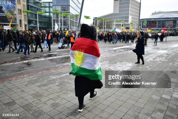 An expatriate Kurd wears a flag she participates in celebrations marking the Kurdish new year, or Newroz, on March 17, 2018 in Hanover, Germany. Many...