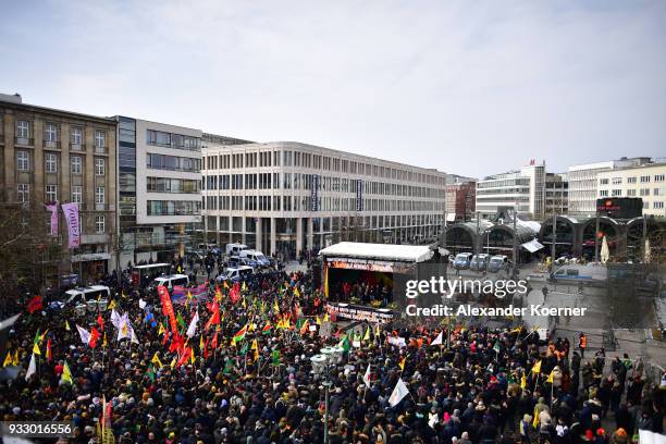 Expatriate Kurds carry YPG flags as they participate in celebrations marking the Kurdish new year, or Newroz, on March 17, 2018 in Hanover, Germany....