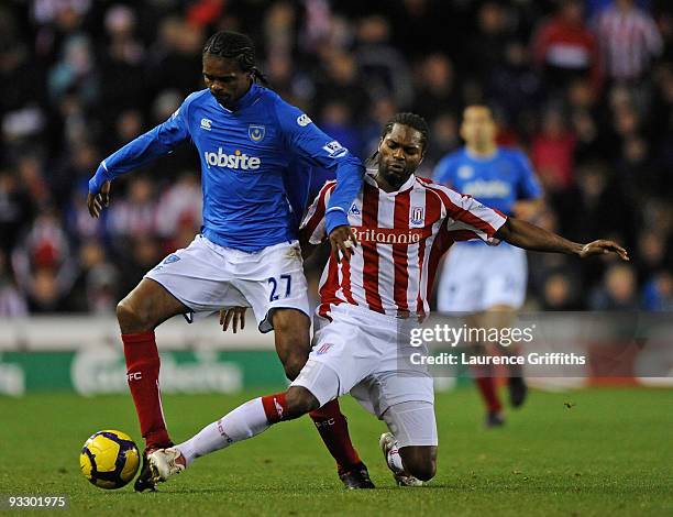 Kanu of Portsmouth battles with Salif Diao of Stoke City during the Barclays Premier League match between Stoke City and Portsmouth at The Britannia...