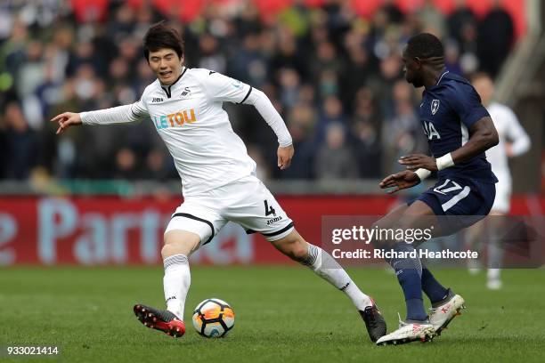 Ki Sung-Yueng of Swansea City is challenged by Moussa Sissoko of Tottenham Hotspur during The Emirates FA Cup Quarter Final match between Swansea...