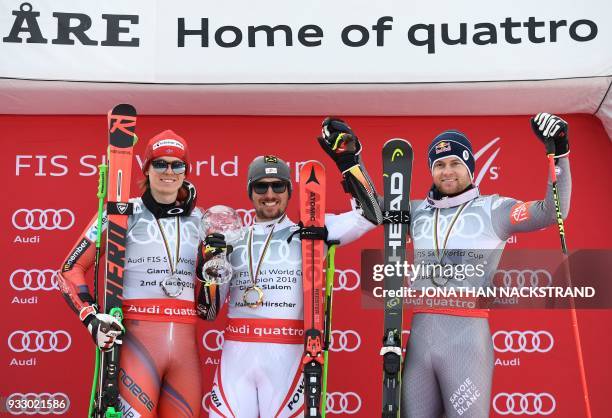 Giant Slalom World Cup overall winners Henrik Kristoffersen of Norway, Marcel Hirscher of Austria and Alexis Pinturault of France pose on the podium...