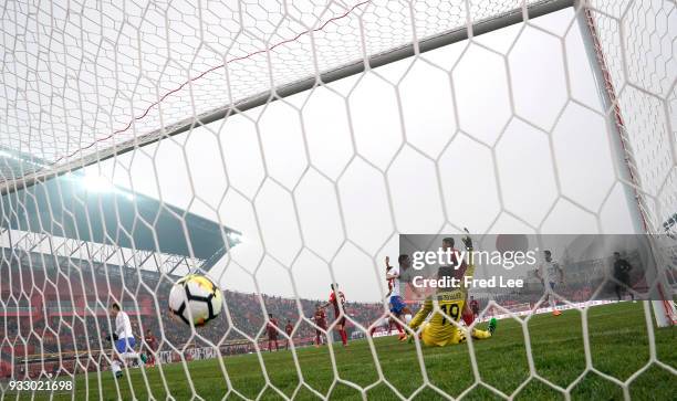 Diego Tardelli Martins of Shandong Luneng Taishan scores a goal past goalkeeper Cheng Yang of Hebei China Fortune FC during the 2018 Chinese Super...
