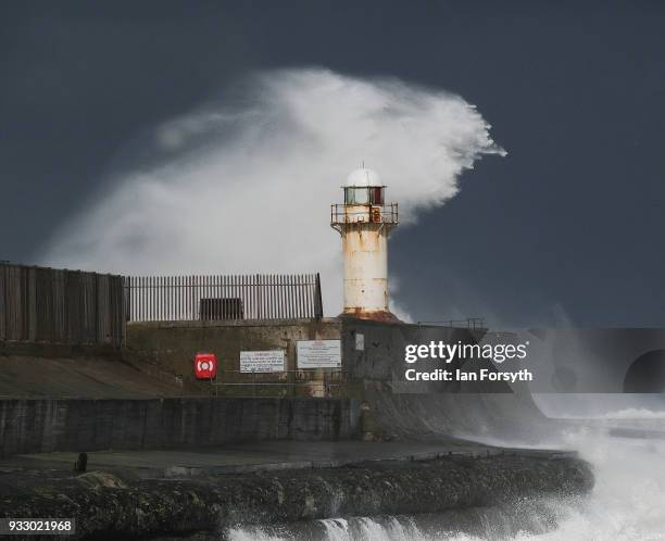 Huge waves crash against the seawall and lighthouse at South Gare near Redcar on March 17, 2018 in Redcar, England. Further bad weather has arrived...