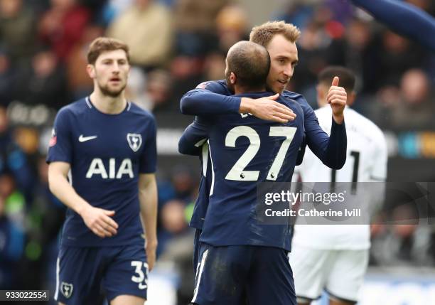 Christian Eriksen of Tottenham Hotspur celebrates with teammate Lucas Moura after scoring his sides third goal during The Emirates FA Cup Quarter...