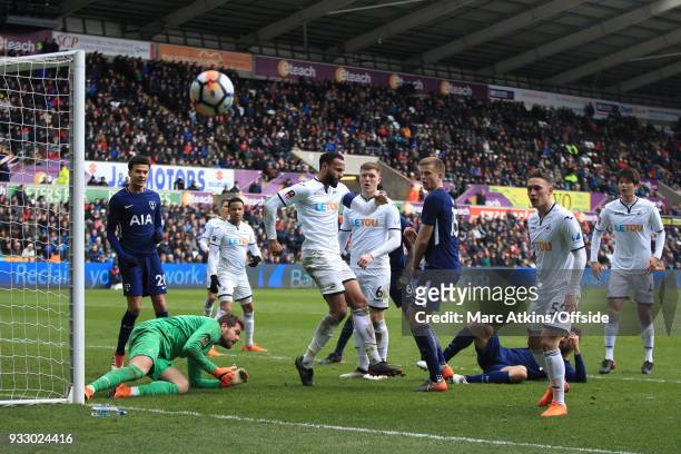 Kyle Bartley of Swansea City clears the ball after a goalmouth scramble during the Emirates FA Cup Quarter Final match between Swansea City and...