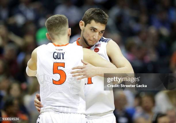 Kyle Guy hugs Ty Jerome of the Virginia Cavaliers against the UMBC Retrievers during the first round of the 2018 NCAA Men's Basketball Tournament at...