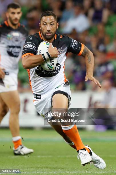 Benji Marshall of the Tigers runs with the ball during the round two NRL match between the Melbourne Storm and the Wests Tigers at AAMI Park on March...