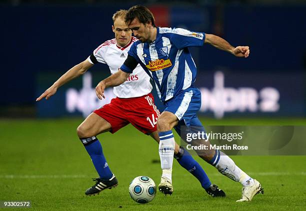 David Jarolim of Hamburg and Christian Fuchs of Bochum battle for the ball during the Bundesliga match between Hamburger SV and VfL Bochum at the HSH...