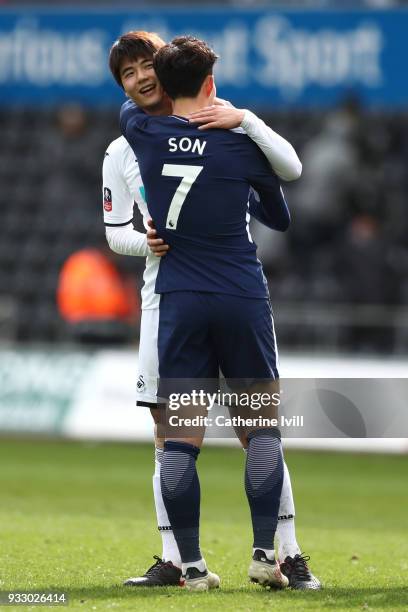 Ki Sung-Yueng of Swansea City and Heung-Min Son of Tottenham Hotspur embrace after The Emirates FA Cup Quarter Final match between Swansea City and...