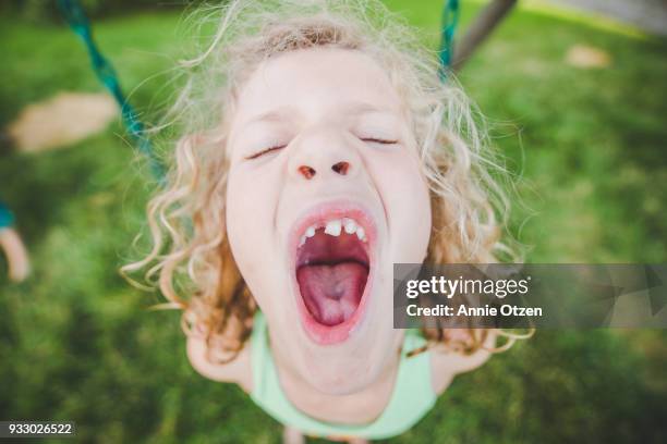 girl with mouth very wide open - girl open mouth stockfoto's en -beelden