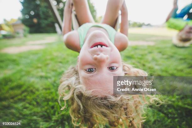 girl hanging upside down - girl upside down stock pictures, royalty-free photos & images