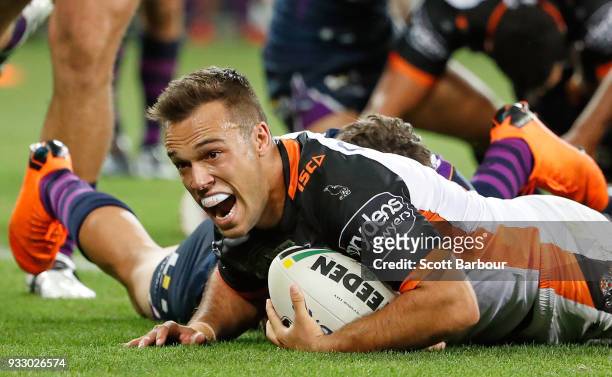 Luke Brooks of the Tigers scores the winning try during the round two NRL match between the Melbourne Storm and the Wests Tigers at AAMI Park on...