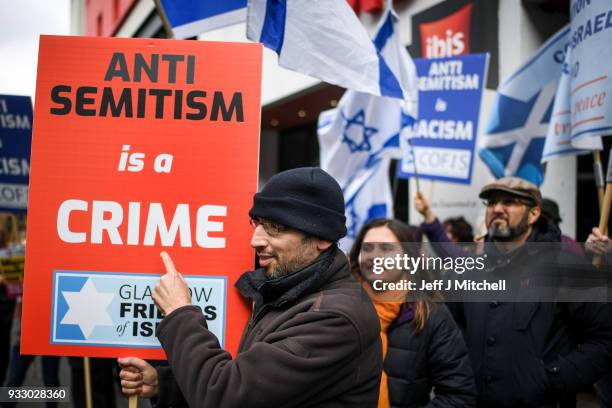 Pro-Israeli and Pro Palestine demonstrators try and stop each other from marching during an anti-racism rally through the city centre on March 17,...