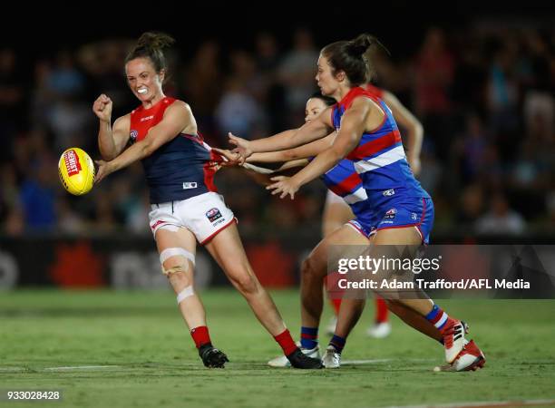 Daisy Pearce of the Demons is tackled by Brooke Lochland and Ellie Blackburn of the Bulldogs during the 2018 AFLW Round 07 match between the Western...