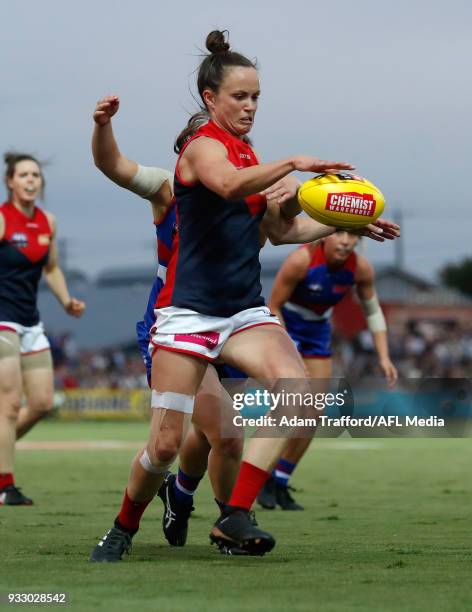 Daisy Pearce of the Demons gets a kick away while being tackled by Kirsty Lamb of the Bulldogs during the 2018 AFLW Round 07 match between the...