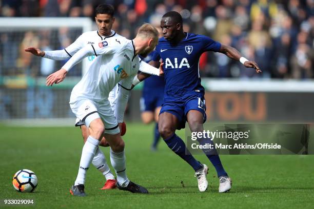 Moussa Sissoko of Tottenham Hotspur in action with Kyle Naughton and Mike van der Hoorn of Swansea City during the Emirates FA Cup Quarter Final...