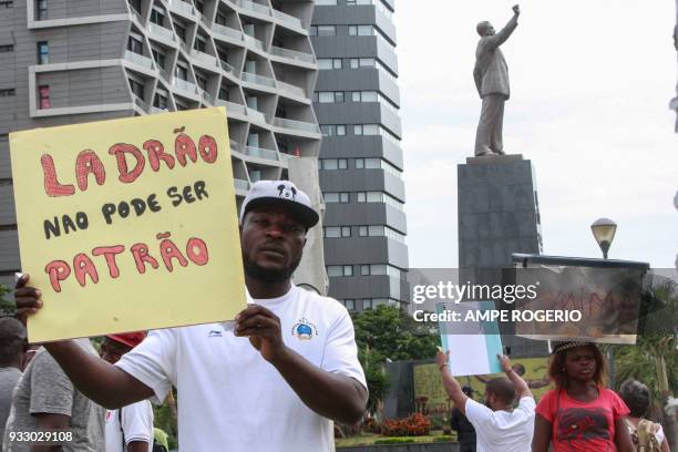 Dozen of people hold placards in down town Luanda, in front of the statue of Agostinho Neto. On March 17 as they protest against the amnesty provided...