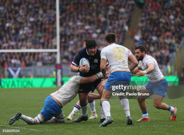 Zander Fagerson of Scotland is tackled by Italian players during the NatWest Six Nations match between Italy and Scotland at Stadio Olimpico on March...