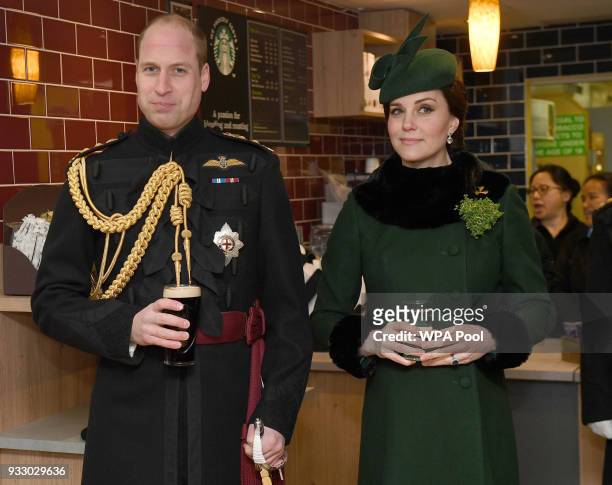 Prince William, Duke Of Cambridge, Colonel of the Irish Guards drinks a pint of Guinness next to Catherine, Duchess of Cambridge as they attend the...