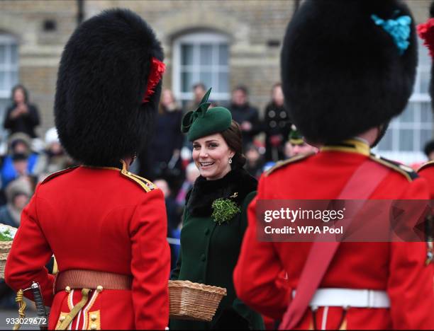 Catherine, Duchess of Cambridge presents the 1st Battalion Irish Guardsmen with shamrocks during the annual Irish Guards St Patrick's Day Parade at...