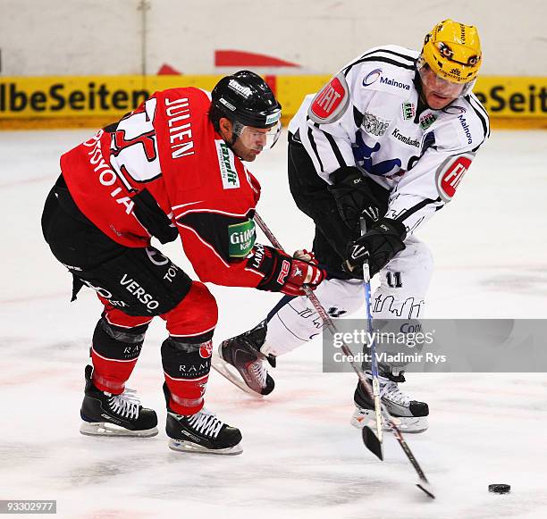 Stephane Julien of Haie and Eric Schneider of Lions battle for the puck during the Deutsche Eishockey Liga game between Koelner Haie and Frankfurt...