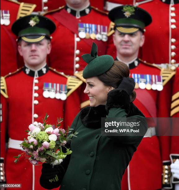 Catherine, Duchess of Cambridge presents the 1st Battalion Irish Guardsmen with shamrocks during the annual Irish Guards St Patrick's Day Parade at...