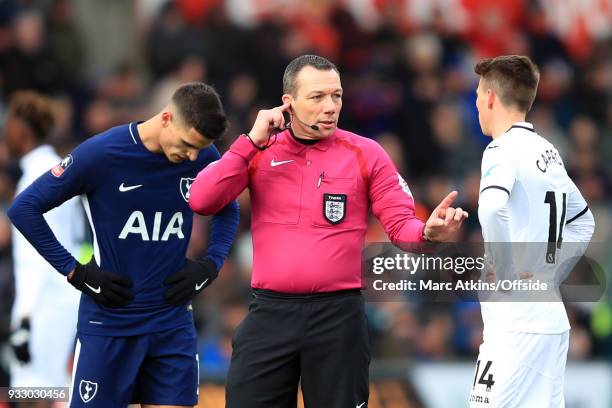 Referee Kevin Friend speaks with Tom Carroll of Swansea City as he consults VAR during the Emirates FA Cup Quarter Final match between Swansea City...