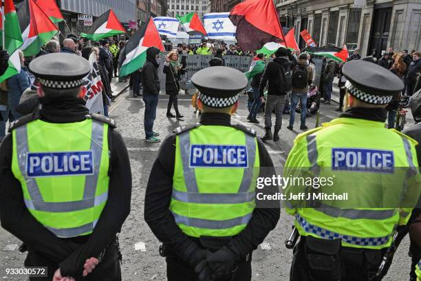 Police watch as Pro-Israeli and Pro Palestine demonstrators try and stop each other from marching during an anti-racism rally through the city centre...