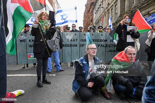 Pro-Israeli and Pro Palestine demonstrators try and stop each other from marching during an anti-racism rally through the city centre on March 17,...