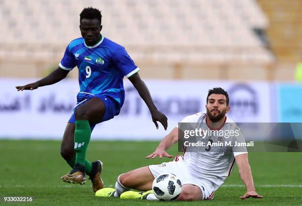 Mohammad reza Khanzadeh of Iran and Kanu Abu in action during the International Friendly between Iran and Sierra Leone at Azadi Stadium on March 17,...