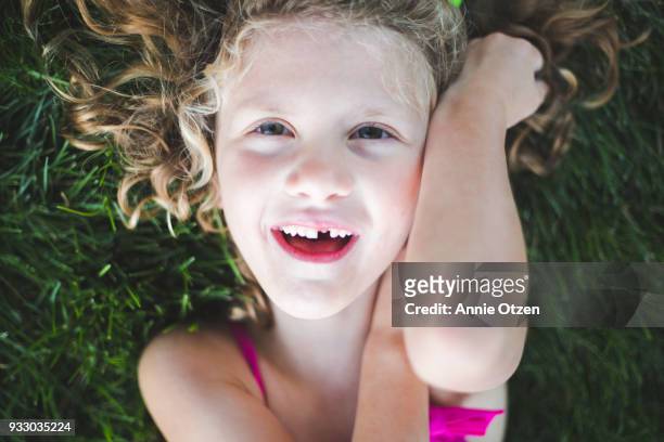 Curly Haired girl With Missing Tooth