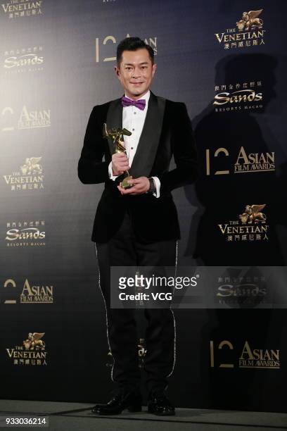 Actor Louis Koo poses with trophy backstage during the 12th Asian Film Awards at the Venetian Hotel on March 17, 2018 in Macao, China.